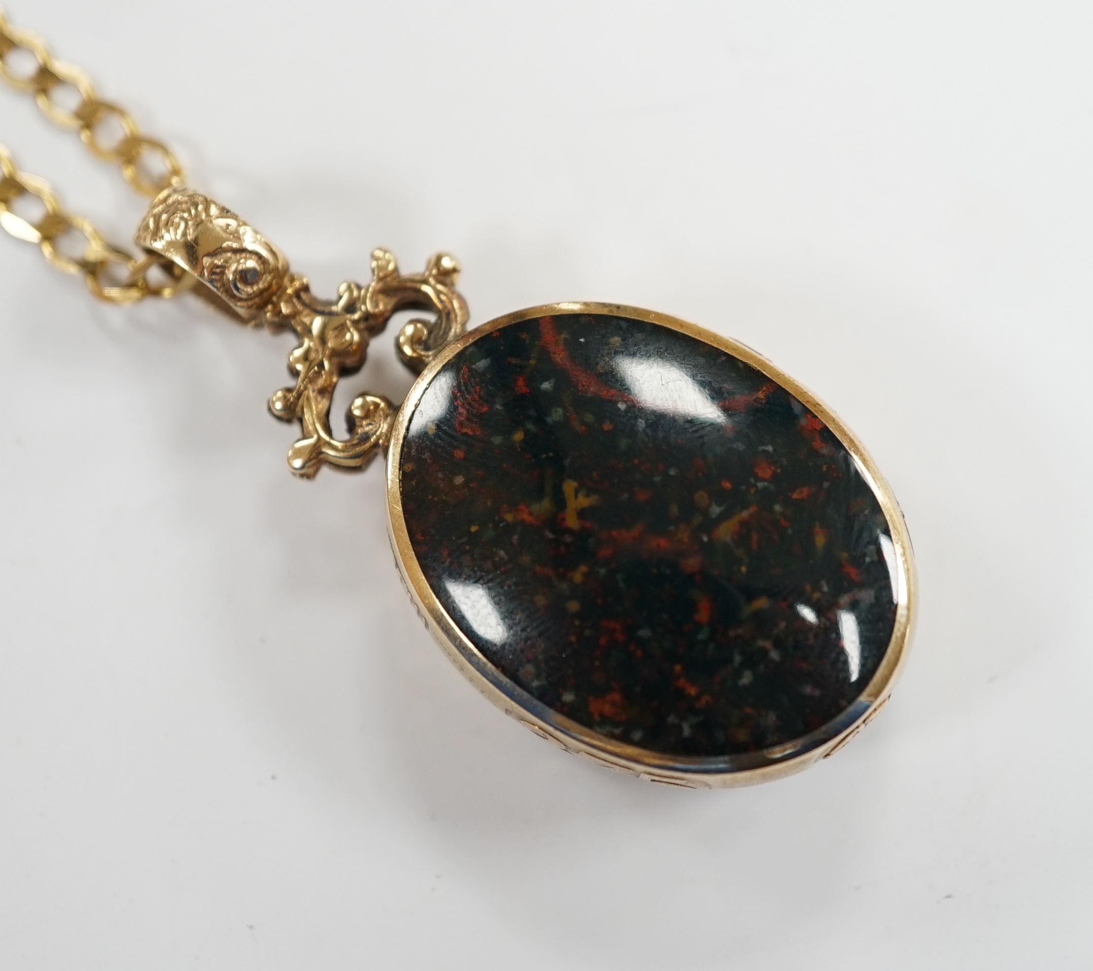 A modern 9ct gold mounted carnelian and bloodstone set oval 'Millennium' pendant, by Davis Scott Walker, overall 49mm, on a 9ct gold curb link chain, 50cm, gross weight 22.9 grams. Fair condition.